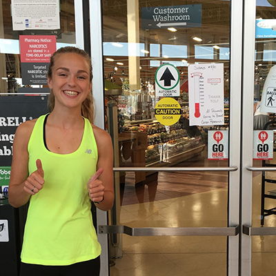 Emma Moore next to GoHere Decal at Sobeys