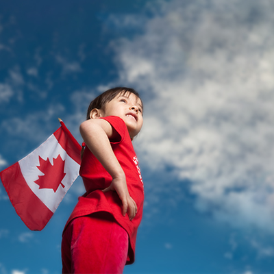 Boy with IBD holding a Canadian flag on Canada Day
