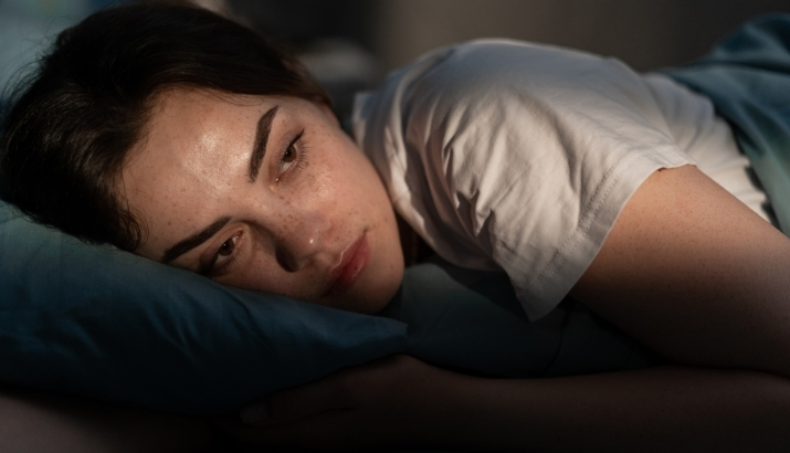An IBD patient with fatigue lying in bed