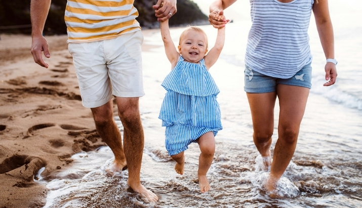 A happy family playing with their young baby girl