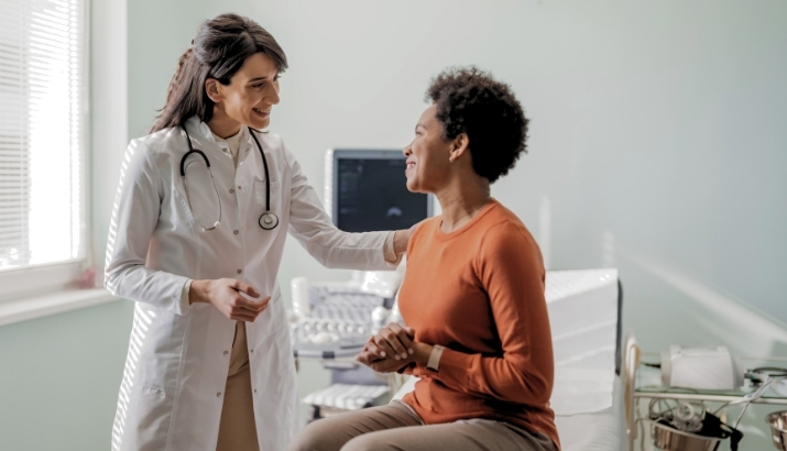 A physician speaking to her patient