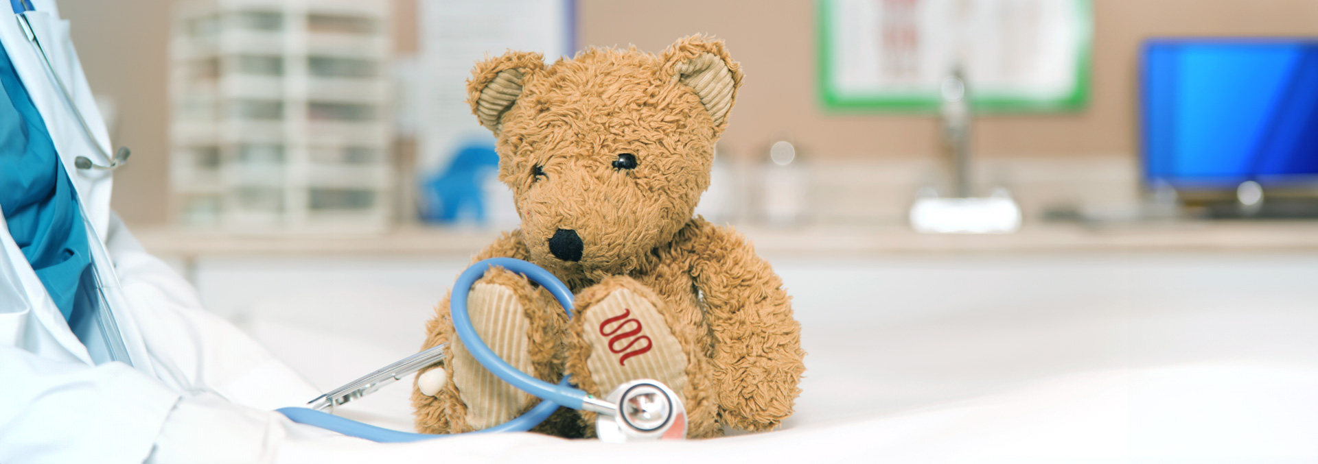 A brown stuffed bear in a medical office.