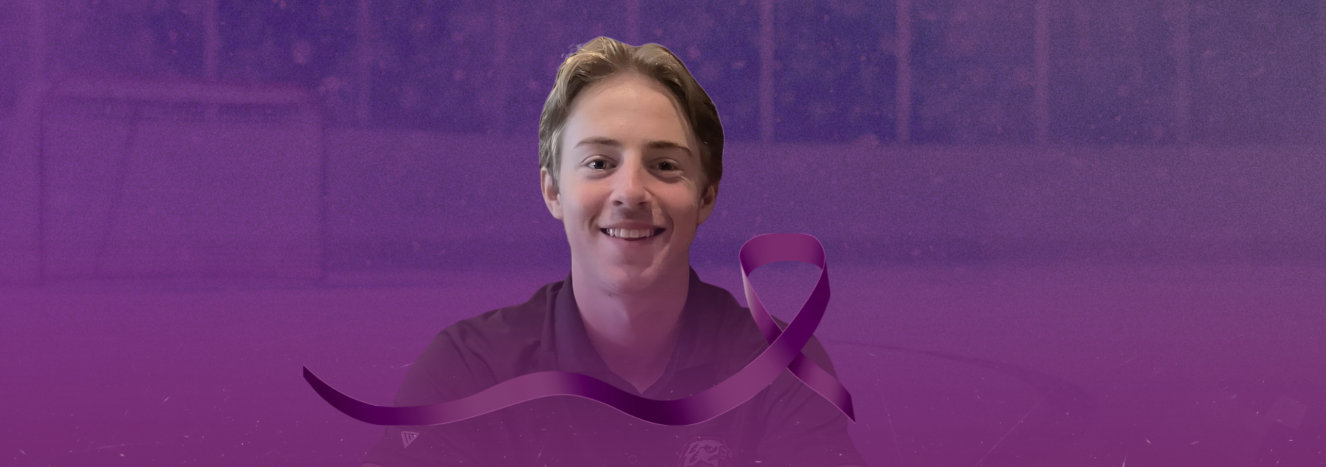 Cohen Massey in front of a purple ribbon representing World IBD Day