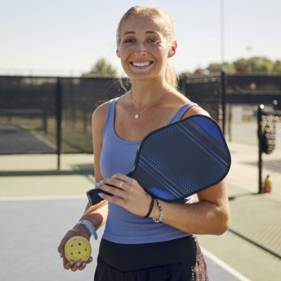 Woman holding a pickleball raquet