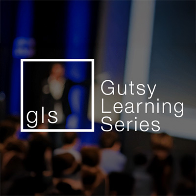 Gutsy Learning Sereies logo on background of a public speaker