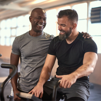 Image of two men talking to each other at the gym