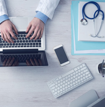 Doctor typing on a laptop