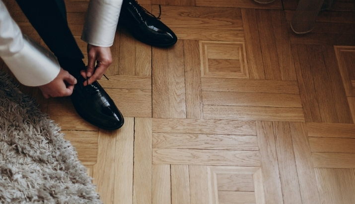 A  person tying their shoe and happy to be able to go outside and not feel like they need to stay in